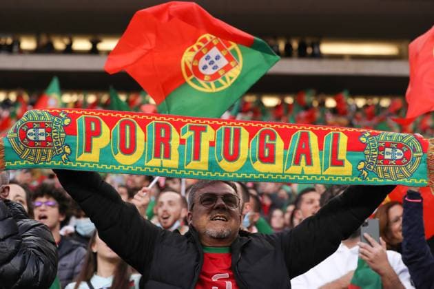 Porto, Portugal, 29th March 2022. Portugal fans hold up scarves and wave flags during the FIFA World Cup, WM, Weltmeisterschaft, Fussball 2022 - European Qualifying match at the Estadio do Dragao, Porto. Picture credit should read: Jonathan Moscrop Sportimage EDITORIAL USE ONLY. No use with unauthorised audio, video, data, fixture lists, club league logos or live services. Online in-match use limited to 120 images, no video emulation. No use in betting, games or single club league player publications. SPI-1609-0105