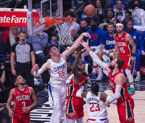 April 3, 2022, Los Angeles, California, USA: Isaiah Hartenstein 55 of the Los Angeles Clippers passes the ball away from their basket as CJ McCollum 3 and Jonas Valanciunas 17 of the New Orleans Pelicans attempt to grab the ball during their NBA, Basketball Herren, USA game on Sunday April 3, 2022 at Crypto.com Arena in Los Angeles, California. Clippers defeat Pelicans, 119-100. ARIANA RUIZ PI Los Angeles USA - ZUMAp124 20220403_zaa_p124_075 Copyright: xArianaxRuizx