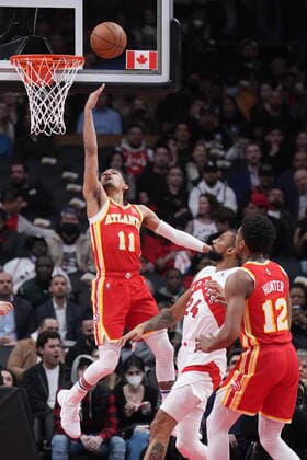 April 5, 2022, TORONTO, ON, CANADA: Atlanta Hawks guard Trae Young (11) scores a basket as Toronto Raptors centre Khem Birch (24) and Hawks forward De Andre Hunter (12) look on during first half NBA, Basketball Herren, USA basketball action in Toronto on Tuesday, April 5, 2022. Canada News - April 5, 2022  - ZUMAc35_ 20220405_zaf_c35_078 Copyright: xNathanxDenettex