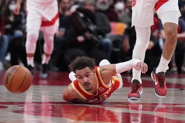 April 5, 2022, TORONTO, ON, CANADA: Atlanta Hawks guard Trae Young (11) looks toward the loose ball as he falls to the floor after being fouled by Toronto Raptors centre Khem Birch, right, during second half NBA, Basketball Herren, USA basketball action in Toronto on Tuesday, April 5, 2022. Canada News - April 5, 2022 - ZUMAc35_ 20220405_zaf_c35_109 Copyright: xNathanxDenettex