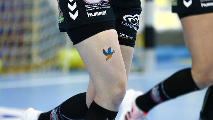 Bilder des Jahres 2022, Sport 04 April Sport Themen der Woche KW14 Sport Bilder des Tages Die Spielerinnen von HL Buchholz 08-Rosengarten tragen auf dem rechten Oberschenkel das Bild einer Friedenstaube in den Farben der ukrainischen Flagge, Fahne, Taube, Tattoo, Abziehbild, Ukrainekrieg, Krieg, Konflikt, Zeichen, Symbol. Frieden, Gedenken an die Opfer des Krieges in der Urkaine, 10.04.2022, Oldenburg (Deutschland), Handball, Bundesliga Frauen, VfL Oldenburg - HL Buchholz 08-Rosengarten *** The players of HL Buchholz 08 Rosengarten wear on the right thigh the image of a peace dove in the colors of the Ukrainian flag, flag, dove, tattoo, decal, Ukraine war, war, conflict, sign, symbol peace, commemoration of the victims of the war in the Urkaine, 10 04 2022, Oldenburg Germany , Handball, Bundesliga Women, VfL Oldenburg HL Buchholz 08 Rosengarten xobx