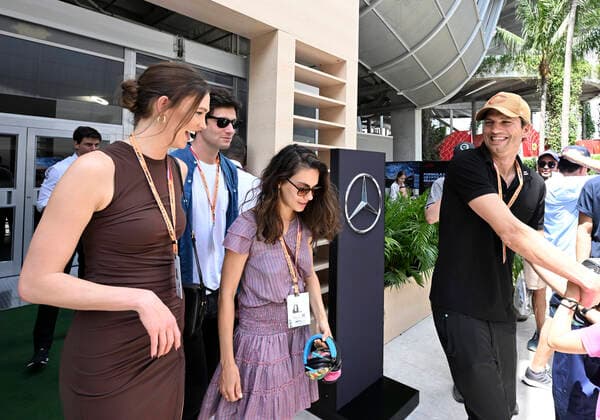 MIAMI GARDENS, FL - MAY 08: Ashton Kutcher and Mila Kunis (center) tour the Mercedes-AMG Petronas hospitality suite with their children prior to the start of the Formula 1 CRYPTO.COM Miami Grand Prix on May 8, 2022 at Miami Autodrome in Miami Gardens, FL. (Photo by Doug Murray Icon Sportswire) AUTO: MAY 08 F1 Crypto.com Miami Grand Prix Icon79620220508028