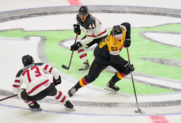 Moritz Seider Nr.53 of Germany Detroit ) compete, fight for the puck against, Noah Gregor Nr. 73 of Canada Maxime Comtois Nr. 44 of Canada in the match GERMANY - CANADA IIHF Ice hockey, Eishockey World Championship, WM, Weltmeisterschaft Group B in Helsinki, Finland, May 13, 2022, Season 2021 2022