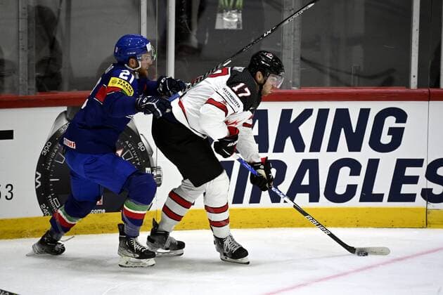 Adam Lowry (R) of Canada shields the puck from Daniel Glira of Italy during the 2022 IIHF Ice hockey, Eishockey World Championships preliminary round group A match between Italy and Canada in Helsinki on May 15, 2022. Helsinki Finland LKFTJK20220515122630VFGI  Copyright: xAnttixAimo-Koivistox