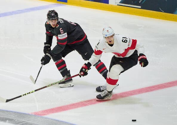 Travis Sanheim Nr. 6 of Canada compete, fight for the puck against, Fabrice Herzog Nr. 61 of Switzerland in the match CANADA - SWITZERLAND of the IIHF Ice hockey, Eishockey World Championship, WM, Weltmeisterschaft Group B in Helsinki, Finland, May 21, 2022, Season 2021 2022
