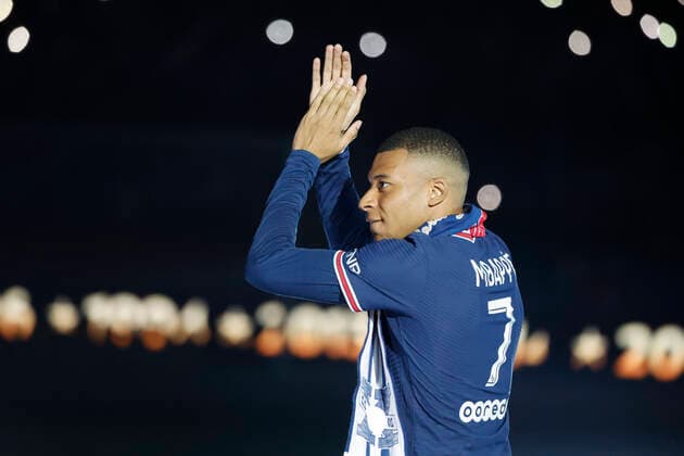 (220522) -- PARIS, May 22, 2022 -- Paris Saint-Germain s French forward Kylian Mbappe celebrates their club s tenth Ligue 1 title during the 2021-2022 Ligue 1 championship trophy ceremony following the French L1 football match between Paris Saint-Germain (PSG) and Metz at the Parc des Princes stadium in Paris on May 21, 2022. (Photo by Rit Heise Xinhua) (SP)FRANCE-PARIS-FOOTBALL-PSG RxItHeinzegaojing 