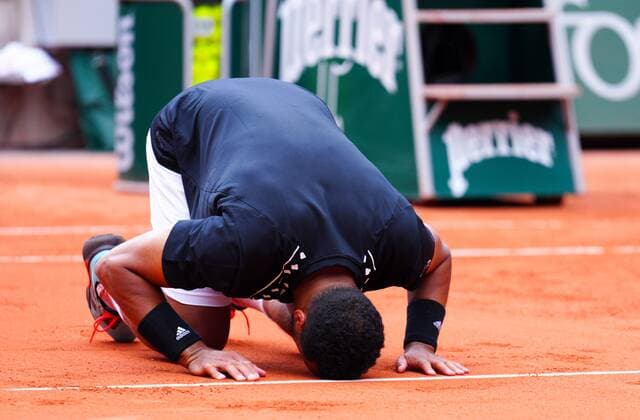 Mandatory Credit: Photo by Javier Garcia Shutterstock (12954043ci) Jo Wilfried Tsonga kneels on the clay after his final ever match French Open Tennis, Day 3, Roland Garros, Paris, France - 24 May 2022 French Open Tennis, Day 3, Roland Garros, Paris, France - 24 May 2022  Copyright: xJavierxGarcia Shutterstockx 12954043ci
