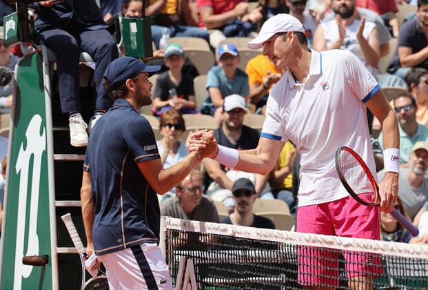 US John Isner (R) shakes hands with Gregoire Barrere of France at the end of their French Tennis Open match at Roland Garros near Paris, France, on Wednesday, May 25, 2022. Isner won 6-4, 6-4, 3-6, 7-6.  PAR20220525109 MAYAxVIDON-WHITE
