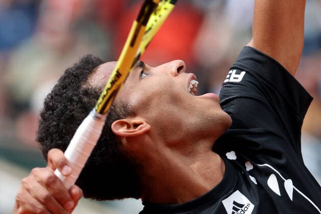 Canadian Felix Auger-Aliassime returns the ball to Spanish Rafael Nadal during their French Tennis Open match at Roland Garros near Paris, France, on Sunday May 29, 2022. Nadal won 3-6, 6-3, 6-2, 3-6, 6-3.  PAR20220529143 MAYAxVIDON-WHITE