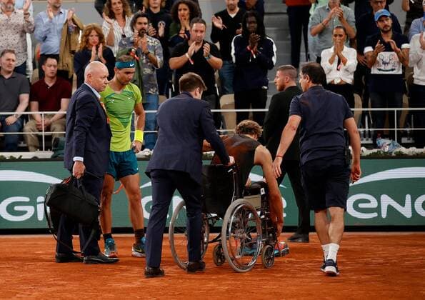 Mandatory Credit: Photo by Ella Ling Shutterstock (12959951e) Alexander Zverev of Germany is led off court in a wheelchair following a fall with Rafael Nadal looking on in concern French Open Tennis, Day 13, Roland Garros, Paris, France - 03 Jun 2022 French Open Tennis, Day 13, Roland Garros, Paris, France - 03 Jun 2022  Copyright: xEllaxLing Shutterstockx 12959951e