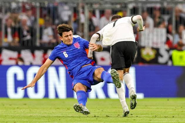 Germany v England UEFA Nations League 07 06 2022. Harry Maguire (6) of England is knocked over by Kai Havertz (7) of Germany during the UEFA Nations League match between Germany and England at Allianz Arena, Munich, Germany on 7 June 2022. Editorial use only , Copyright: xNigelxKeenex PSI-15374-0025