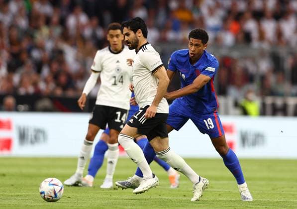 Munich, Germany, 7th June 2022. Ilkay Gundogan of Germany gets clear of Jude Bellingham of England during the UEFA Nations League match at Allianz Arena, Munich. Picture credit should read: David Klein Sportimage EDITORIAL USE ONLY. No use with unauthorised audio, video, data, fixture lists, club league logos or live services. Online in-match use limited to 120 images, no video emulation. No use in betting, games or single club league player publications. SPI-1728-0061