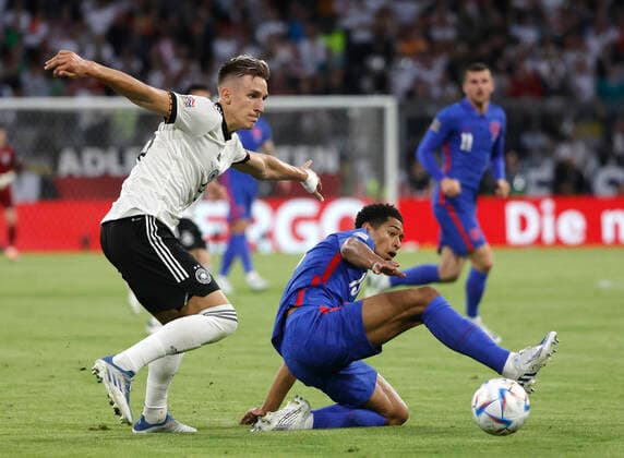(220608) -- MUNICH, June 8, 2022 -- Germany s Nico Schlotterbeck (L) vies with England s Jude Bellingham during their UEFA Nations League A football match at the Allianz Arena in Munich, Germany on June 7, 2022. (Photo by Philippe Ruiz Xinhua) (SP)GERMANY-MUNICH-FOOTBALL-UEFA NATIONS LEAGUE-GERMANY VS ENGLAND FeixLipu¡¤luyizi 