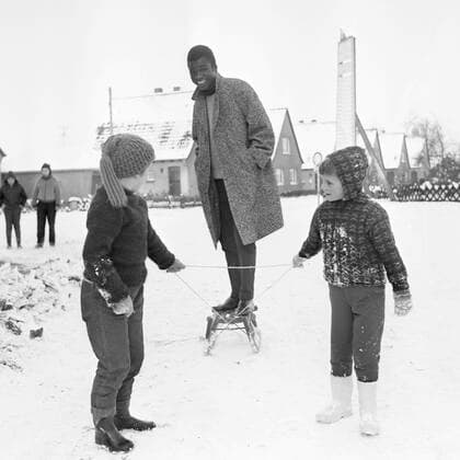 Guy ACOLATSE, Togo, Fussballspieler, (FC St. Pauli), spielt im Schnee, der erste Schnee, laesst sich von Kindern auf einem Schlitten ziehen, Guy Acolatse war der erste farbige Spieler in der Fussball-Bundesliga Fussball, 04.08.1963 Â *** Guy ACOLATSE, Togo, football player, FC St Pauli , plays in the snow, the first snow, lets himself be pulled by children on a sledge, Guy Acolatse was the first colored player in the Bundesliga football, 04 08 1963 Â