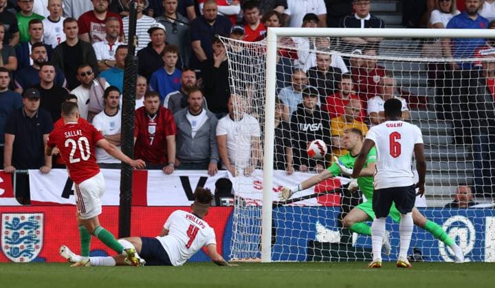 Wolverhampton, England, 14th June 2022. Roland Sallai of Hungary (l) scores the first goal past Aaron Ramsdale of England during the UEFA Nations League match at Molineux, Wolverhampton. Picture credit should read: Darren Staples Sportimage EDITORIAL USE ONLY. No use with unauthorised audio, video, data, fixture lists, club league logos or live services. Online in-match use limited to 120 images, no video emulation. No use in betting, games or single club league player publications. SPI-1734-0028