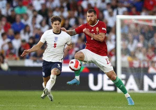 Wolverhampton, England, 14th June 2022. John Stones of England tussles with Martin Adam of Hungary during the UEFA Nations League match at Molineux, Wolverhampton. Picture credit should read: Darren Staples Sportimage EDITORIAL USE ONLY. No use with unauthorised audio, video, data, fixture lists, club league logos or live services. Online in-match use limited to 120 images, no video emulation. No use in betting, games or single club league player publications. SPI-1734-0072