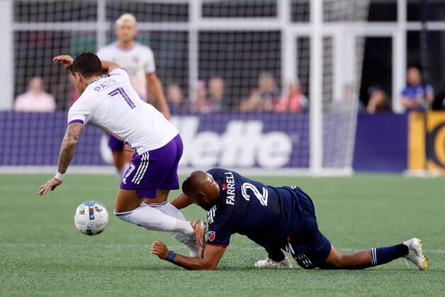 FOXBOROUGH, MA - JUNE 15: New England Revolution defender Andrew Farrell (2) fouls Orlando City SC forward Alexandre Pato (7) for a yellow card during a match between the New England Revolution and Orlando City SC on June 15, 2022, at Gillette Stadium in Foxborough, Massachusetts. (Photo by Fred Kfoury III Icon Sportswire) SOCCER: JUN 15 MLS, Fussball Herren, USA - Orlando City SC at New England Revolution Icon482220615018