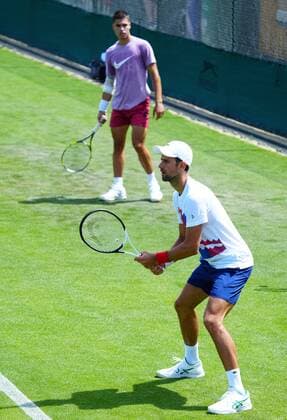 Mandatory Credit: Photo by Javier Garcia Shutterstock (12994278m) Carlos Alcaraz looks towards Novak Djokovic Wimbledon Tennis Championship Practice and Previews, The All England Lawn Tennis and Croquet Club, London, UK - 21 Jun 2022 Wimbledon Tennis Championship Practice and Previews, The All England Lawn Tennis and Croquet Club, London, UK - 21 Jun 2022  Copyright: xJavierxGarcia Shutterstockx 12994278m