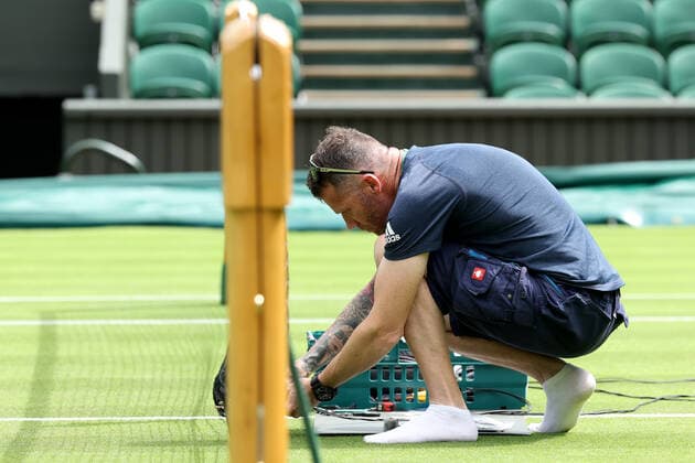 25th June 2022, All England Lawn Tennis and Croquet Club, London, England; Wimbledon Tennis tournament; Ground staff make last minute adjustments at the net  ActionPlus12402291 ShaunxBrooks