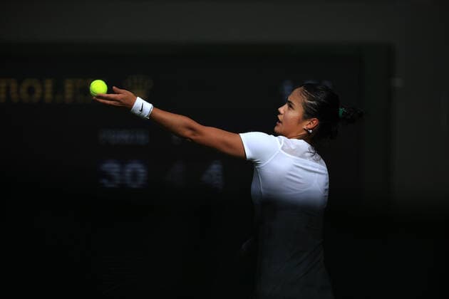 Tennis - Wimbledon (Day 1) 27th June 2022 - Tennis - Wimbledon (Day 1) - Emma Raducanu (GBR) serves during her Ladies Singles 1st Round match against Alison Van Uytvanck (BEL) - Photo: Simon Stacpoole Offside. London UK Copyright: xSimonxStacpoolexOffside