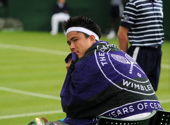 Tennis - 2022 Wimbledon Championships - Week One - Day Two (Tuesday) - All England Lawn Tennis Club, Wimbledon - Tuesday 28th June 2022 Taro Daniel v Sebastian Baez Taro Daniel of Japan wraps himself in a Wimbledon towel 