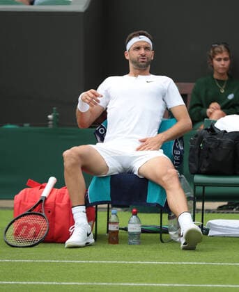 Bulgarian Grigor Dimitrov retires with a groin strain in his first round match against American Steve Johnson on day two of the 2022 Wimbledon championships in London on June 28, 2022.  LON2022062801 HUGOxPHILPOTT