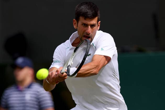 29th June 2022, All England Lawn Tennis and Croquet Club, London, England; Wimbledon Tennis tournament; Novak Djokovic plays a backhand to Thanasi Kokkinakis in the mens singles  ActionPlus12403041 ShaunxBrooks