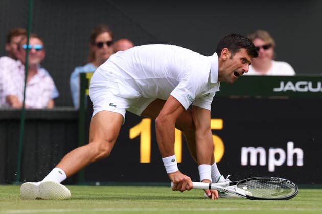 1st July 2022, All England Lawn Tennis and Croquet Club, London, England; Wimbledon Tennis tournament; Novak Djokovic slips during his match with Miomir Kecmanovic in the mens singles  ActionPlus12403623 ShaunxBrooks