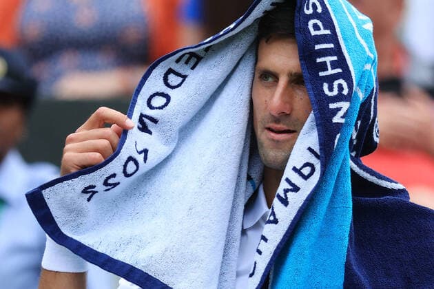 Tennis - Wimbledon (Day 5) 1st July 2022 - Tennis - Wimbledon (Day 5) - Novak Djokovic (SRB) rests a towel over his head during a break in play in his Gentlemen s Singles 3rd Round match against Miomir Kecmanovic (SRB) - Photo: Simon Stacpoole Offside. London UK Copyright: xSimonxStacpoolexOffside