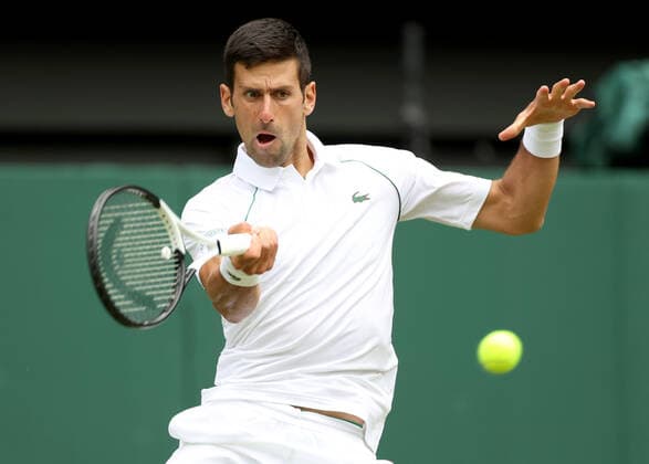 (220702) -- LONDON, July 2, 2022 -- Novak Djokovic hits a return during the men s singles third round match between Novak Djokovic of Serbia and Miomir Kecmanovic of Serbia at Wimbledon Tennis Championship in London, Britain, on July 1, 2022. ) (SP)BRITAIN-LONDON-TENNIS-WIMBLEDON-MEN S SINGLES LixYing 