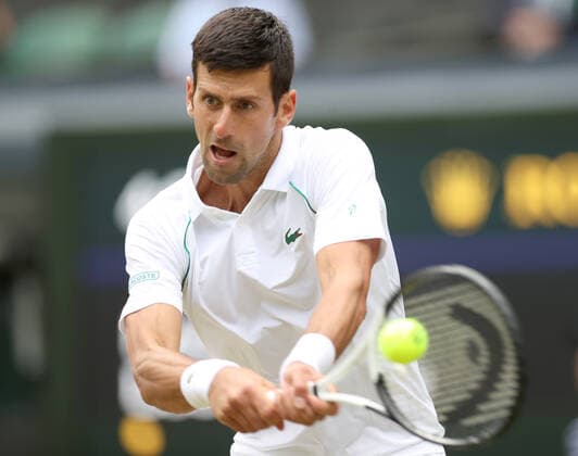(220702) -- LONDON, July 2, 2022 -- Novak Djokovic hits a return during the men s singles third round match between Novak Djokovic of Serbia and Miomir Kecmanovic of Serbia at Wimbledon Tennis Championship in London, Britain, on July 1, 2022. ) (SP)BRITAIN-LONDON-TENNIS-WIMBLEDON-MEN S SINGLES LixYing 