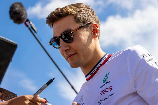 3rd July 2022, Silverstone Circuit, Silverstone, Northamptonshire, England: British F1 Grand Prix, Race day: Mercedes-AMG Petronas F1 Team driver George Russell signs an autograph  ActionPlus12404504 TimxWilliams