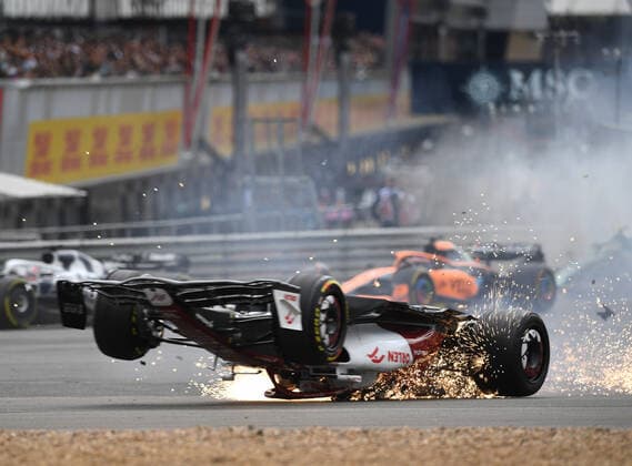 3rd July 2022, Silverstone Circuit, Silverstone, Northamptonshire, England: British F1 Grand Prix, Race day: Zhou Guanyu of China driving the (24) Alfa Romeo F1 C42 Ferrari is hit at the start and his car rolls, sliding upside down towards the barriers and gravel  ActionPlus12404622 SimonxWest