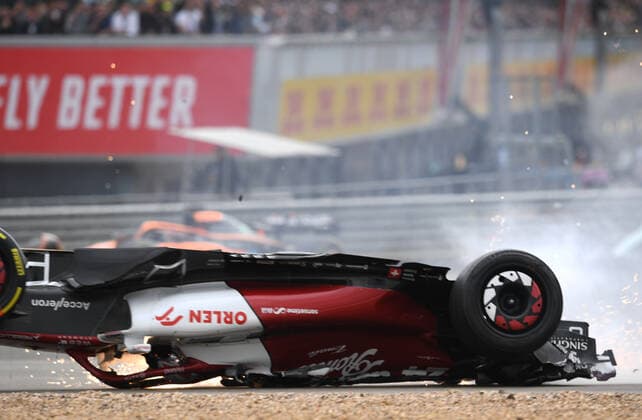 3rd July 2022, Silverstone Circuit, Silverstone, Northamptonshire, England: British F1 Grand Prix, Race day: Zhou Guanyu of China driving the (24) Alfa Romeo F1 C42 Ferrari is hit at the start and his car rolls, sliding upside down towards the barriers and gravel  ActionPlus12404625 SimonxWest