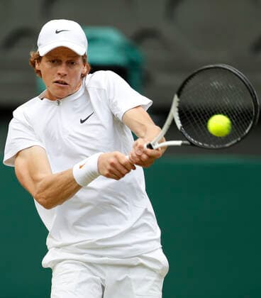 (220704) -- LONDON, July 4, 2022 -- Jannik Sinner of Italy hits a return during the men s singles fourth round match against Carlos Alcaraz of Spain at Wimbledon tennis Championship in London, Britain, on July 3, 2022. ) (SP)BRITAIN-LONDON-TENNIS-WIMBLEDON-MEN S SINGLES HanxYan 