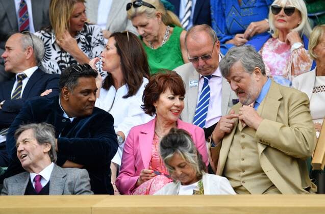 Mandatory Credit: Photo by James Veysey Shutterstock (13012861o) Krishnendu Majumdar, Kathy Lette and Stephen Fry in the Royal Box on Centre Court Wimbledon Tennis Championships, Day 8, The All England Lawn Tennis and Croquet Club, London, UK - 04 Jul 2022 Wimbledon Tennis Championships, Day 8, The All England Lawn Tennis and Croquet Club, London, UK - 04 Jul 2022  Copyright: xJamesxVeysey Shutterstockx 13012861o