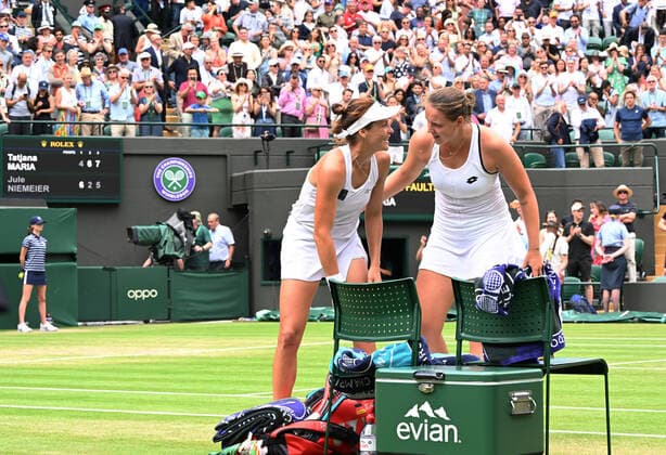 Tennis Championships - Week One - Day Eight - All England Lawn Tennis Club, Wimbledon - Tuesday 5th July 2022 Womens Singles Tatjana Maria (GER) v Jule Niemeier (GER) Winner, Tatjana Maria of Germany shares a joke with Jule Niemeier after the match 