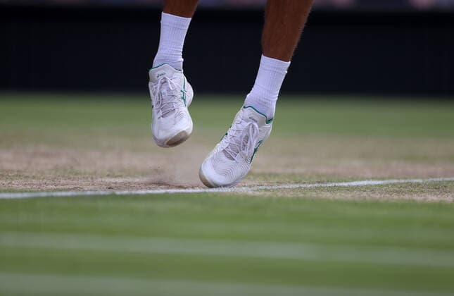 (220706) -- LONDON, July 6, 2022 -- Novak Djokovic of Serbia competes during the men s singles quarter-final match against Jannik Sinner of Italy at Wimbledon Tennis Championship in London, Britain, on July 5, 2022. ) (SP)BRITAIN-LONDON-TENNIS-WIMBLEDON-MEN S SINGLES-QUARTERFINALS LixYing 