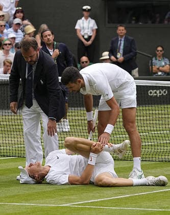 Tennis: Wimbledon championships Novak Djokovic of Serbia (top) and Jannik Sinner of Italy are pictured during the quarterfinals of the Wimbledon tennis tournament in London on July 5, 2022.  A14AA0001310922P