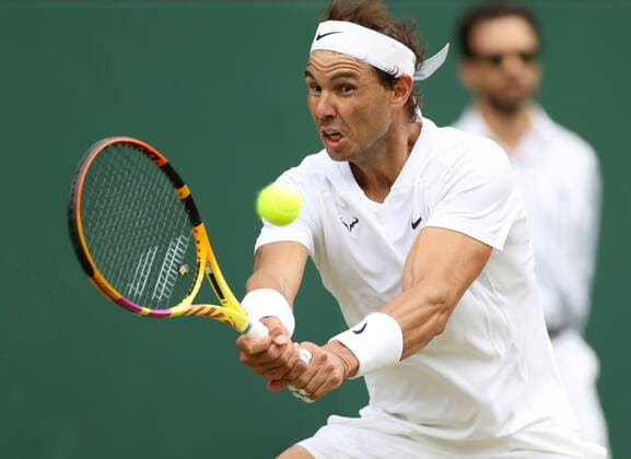 (220707) -- LONDON, July 7, 2022 -- Rafael Nadal of Spain hits a return during the men s singles quarter-final match against Taylor Fritz of the United States at Wimbledon Tennis Championship in London, Britain, on July 6, 2022. ) (SP)BRITAIN-LONDON-TENNIS-WIMBLEDON-MEN S SINGLES-QUARTERFINALS LixYing 