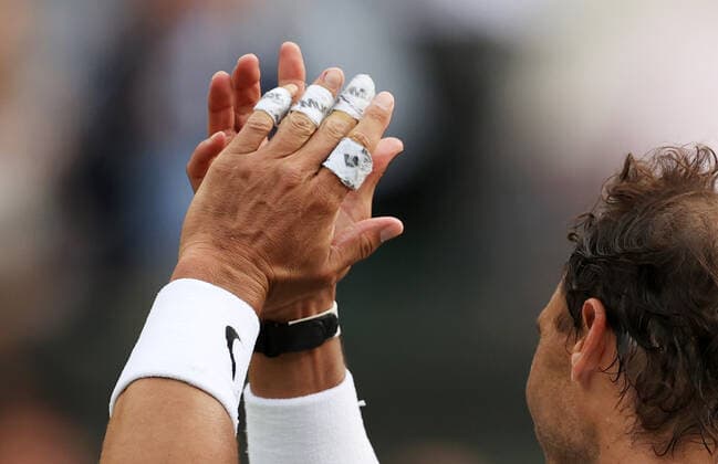 (220707) -- LONDON, July 7, 2022 -- Photo taken on July 6, 2022 shows a detailed view of bandages on the fingers of Rafael Nadal of Spain as he celebrates after winning the men s singles quarter-final match against Taylor Fritz of the United States at Wimbledon Tennis Championship in London, Britain. ) (SP)BRITAIN-LONDON-TENNIS-WIMBLEDON-MEN S SINGLES-QUARTERFINALS LixYing 