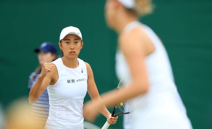 (220707) -- LONDON, July 7, 2022 -- China s Zhang Shuai (L) Belgium s Elise Mertens react during the women s doubles quarter-final match against Slovenia s Andreja Klepac Chile s Alexa Guarachi at Wimbledon Tennis Championship in London, Britain, on July 6, 2022. ) (SP)BRITAIN-LONDON-TENNIS-WIMBLEDON-WOMEN S DOUBLES-QUARTERFINALS LixYing 
