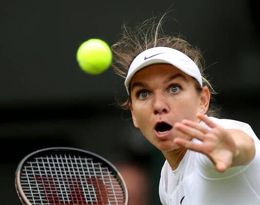 (220707) -- LONDON, July 7, 2022 -- Simona Halep of Romania hits a return during the women s singles quarter-final match against Amanda Anisimova of the United States at Wimbledon Tennis Championship in London, Britain, on July 6, 2022. ) (SP)BRITAIN-LONDON-TENNIS-WIMBLEDON-WOMEN S SINGLES-QUARTERFINALS LixYing 