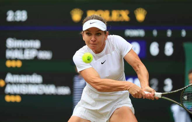 (220707) -- LONDON, July 7, 2022 -- Simona Halep of Romania hits a return during the women s singles quarter-final match against Amanda Anisimova of the United States at Wimbledon Tennis Championship in London, Britain, on July 6, 2022. ) (SP)BRITAIN-LONDON-TENNIS-WIMBLEDON-WOMEN S SINGLES-QUARTERFINALS LixYing 