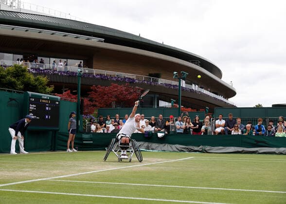 7th July 2022, All England Lawn Tennis and Croquet Club, London, England; Wimbledon Tennis tournament; Alfie Hewett (GBR) serves to Gordon Reid (GBR) in mens wheelchair quarter-final match  ActionPlus12405653 JohnxPatrickxFletcher