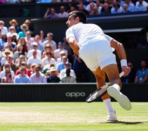 Mandatory Credit: Photo by Javier Garcia Shutterstock (13018051bn) Novak Djokovic chases a ball and plays it between his legs during his semi-final match Wimbledon Tennis Championships, Day 12, The All England Lawn Tennis and Croquet Club, London, UK - 08 Jul 2022 Wimbledon Tennis Championships, Day 12, The All England Lawn Tennis and Croquet Club, London, UK - 08 Jul 2022  Copyright: xJavierxGarcia Shutterstockx 13018051bn