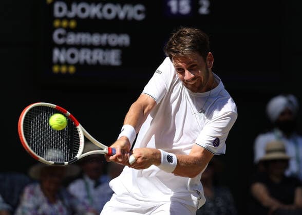 8th July 2022, All England Lawn Tennis and Croquet Club, London, England; Wimbledon Tennis tournament; Cameron Norrie (GBR) plays a backhand to Novak& xa0;Djokovic (SRB) in the mens singles semi-final match  ActionPlus12406046 JohnxPatrickxFletcher