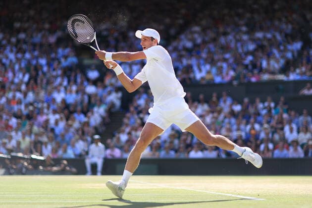 Tennis - Wimbledon (Day 12) 8th July 2022 - Tennis - Wimbledon (Day 12) - Novak Djokovic (SRB) jumps up to play a volley during his Gentlemen s Singles Semi Final match - Photo: Simon Stacpoole Offside. London UK Copyright: xSimonxStacpoolexOffside