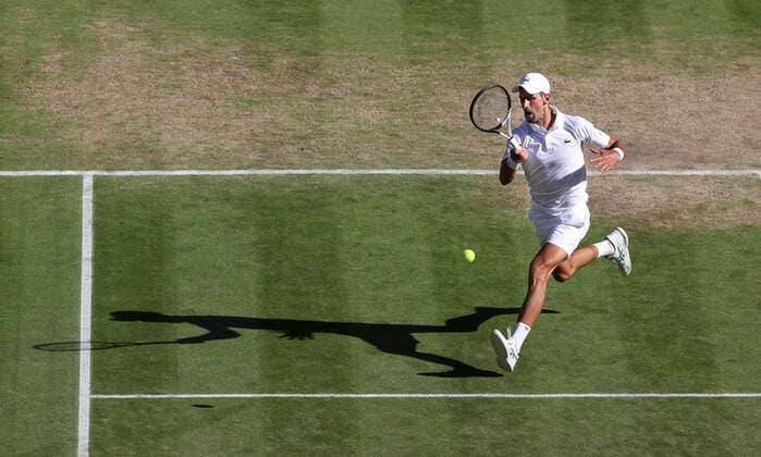 (220709) -- LONDON, July 9, 2022 -- Novak Djokovic of Serbia hits a return during the men s singles semifinal match against Cameron Norrie of Great Britain at Wimbledon Tennis Championship in London, Britain, on July 8, 2022. ) (SP)BRITAIN-LONDON-TENNIS-WIMBLEDON-MEN S SINGLES-SEMIFINALS HanxYan 