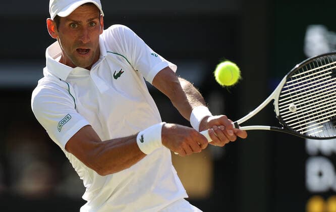 (220709) -- LONDON, July 9, 2022 -- Novak Djokovic of Serbia hits a return during the men s singles semifinal match against Cameron Norrie of Great Britain at Wimbledon Tennis Championship in London, Britain, on July 8, 2022. ) (SP)BRITAIN-LONDON-TENNIS-WIMBLEDON-MEN S SINGLES-SEMIFINALS LixYing 